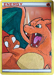 A Fire Energy card with Charizard painted on top.